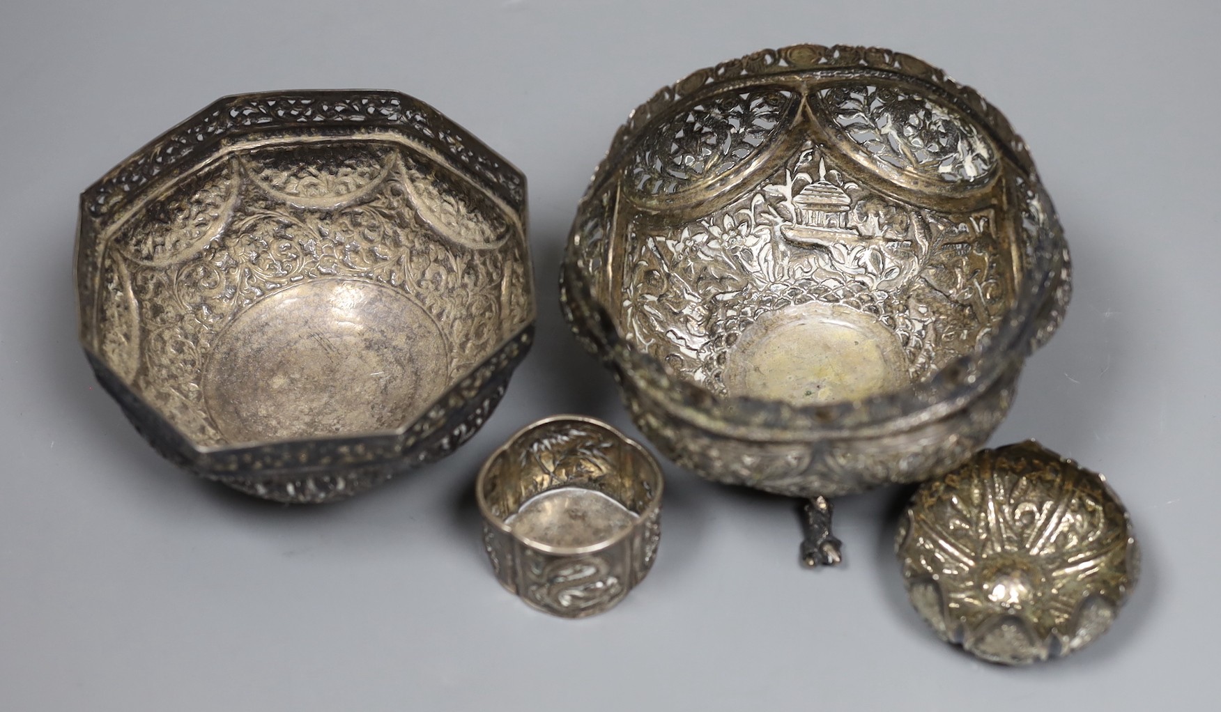 Two early 20th century Indian repousse white metal bowls, widest 12cm, a similar small dish and a salt.